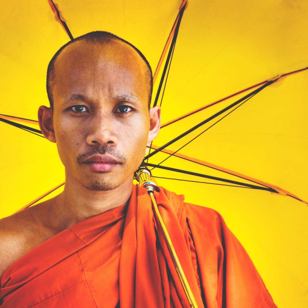 buddhist-monk-holding-umbrella-ceremony-concept-PGEF86M.jpg