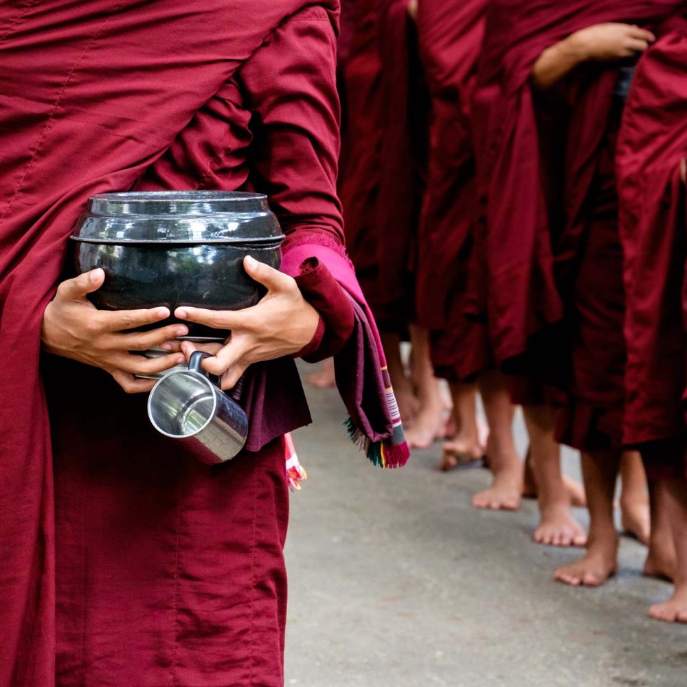 detail-of-buddhist-monks-crowd-and-person-holding-PKCY67V.jpg